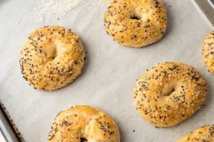 Golden baked high protein bagels on a sheet pan
