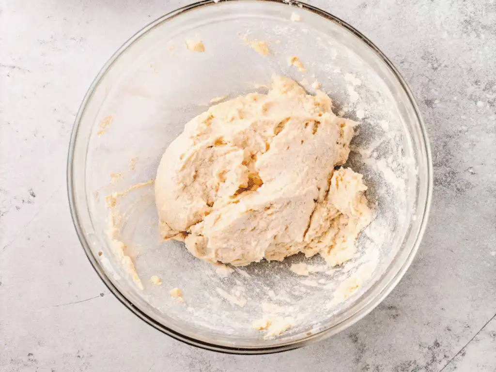 Blended cottage cheese bagel dough in a glass bowl