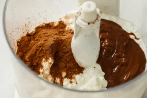 Cottage cheese, cocoa powder, and melted chocolate in blender