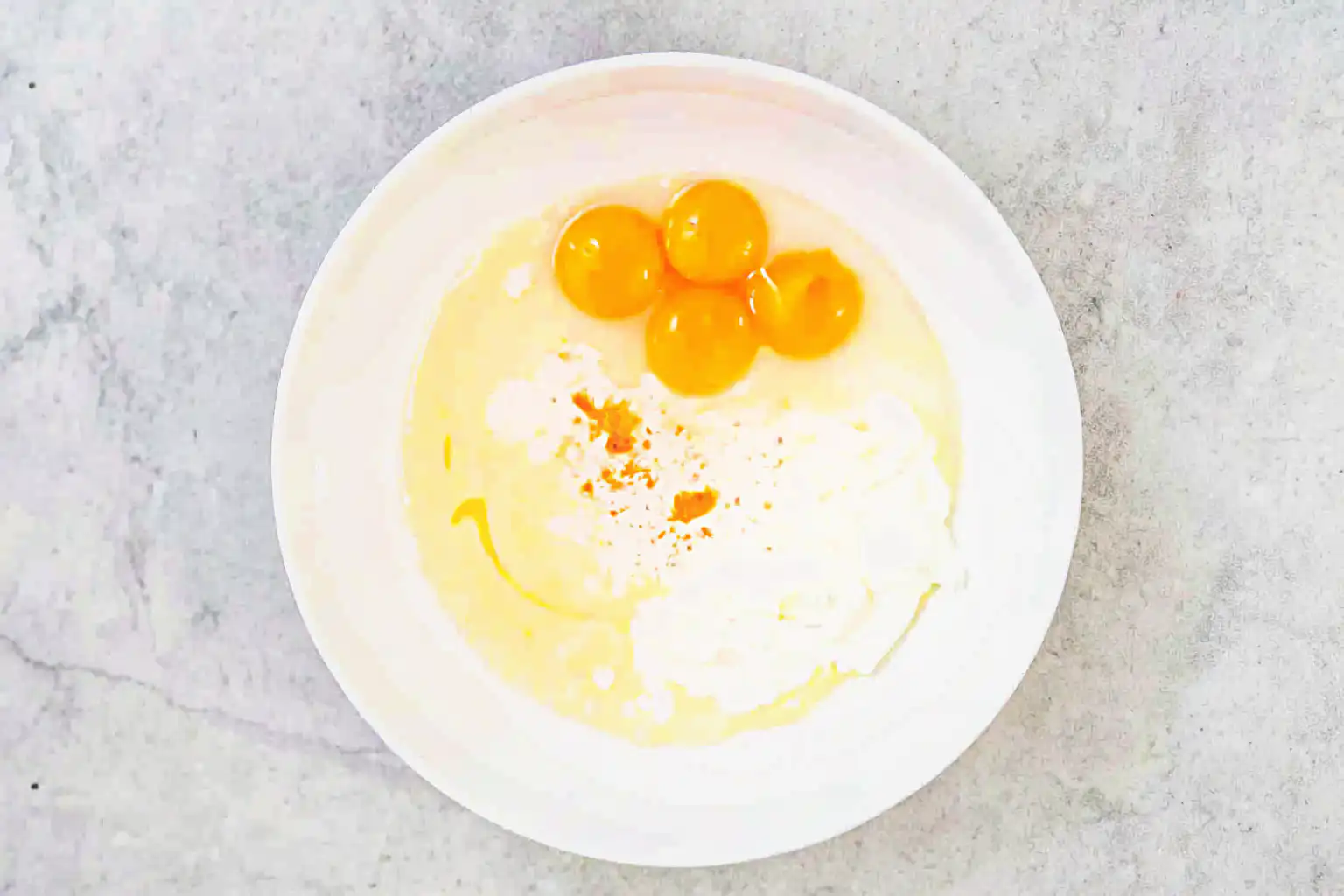 Ingredients for cloud cake with eggs and condensed milk in a bowl