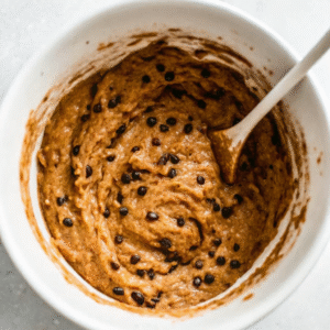 Chocolate chips stirred into banana protein muffin batter