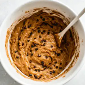Chocolate chips stirred into banana protein muffin batter
