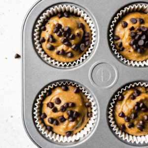 Muffin tray filled with banana protein batter