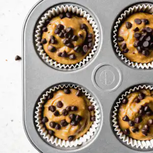 Muffin tray filled with banana protein batter