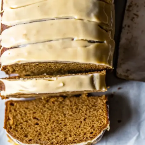 Brown Sugar Pumpkin Loaf (Easy Fall Dessert) Brown Sugar Pumpkin Loaf Freshly baked brown sugar pumpkin loaf sliced on parchment paper, topped with creamy brown sugar icing.