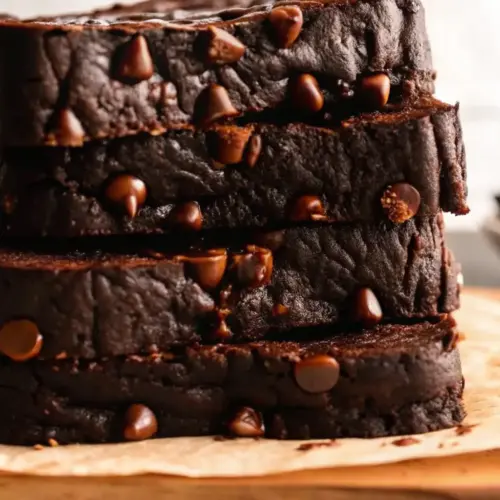 Moist Chocolate Pumpkin Bread Recipe | Rich, Gooey & Easy chocolate pumpkin bread Stacked slices of moist chocolate pumpkin bread filled with gooey chocolate chips, a rich fall dessert loaf recipe.