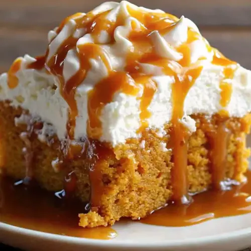 Moist Pumpkin Poke Cake with Caramel & Whipped Topping Pumpkin Poke Cake Moist pumpkin poke cake topped with whipped cream and drizzled caramel sauce on a white plate.