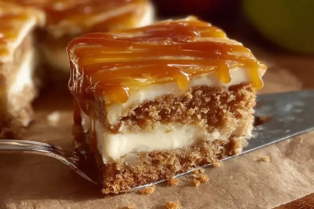 Delicious slice of Caramel Apple Cake topped with caramel drizzle and apple slices.