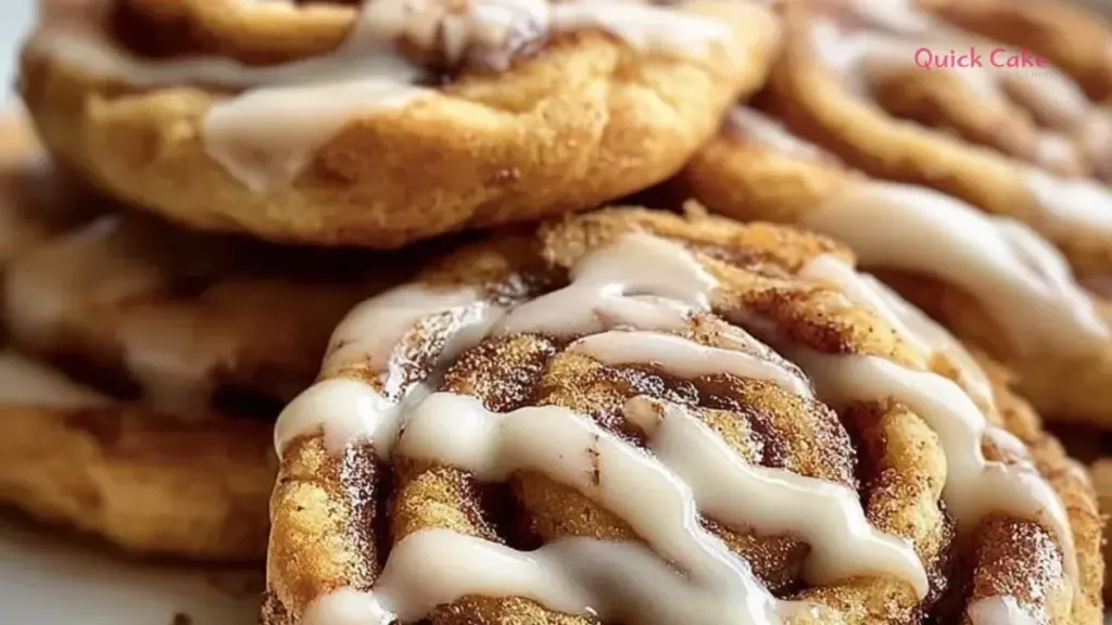 Freshly baked Cinnamon Roll Cookies drizzled with icing on a wooden tray.