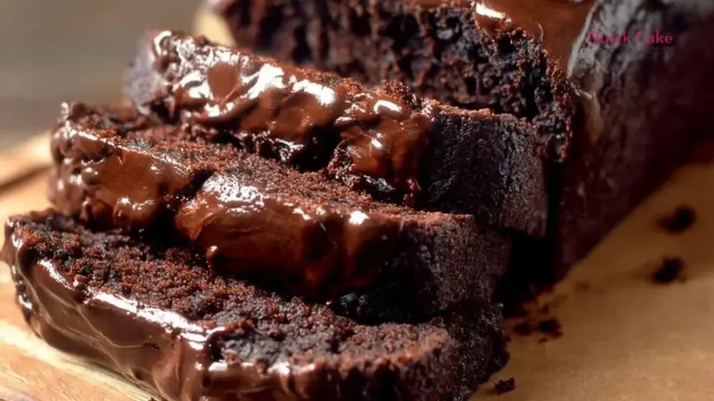 Loaf of dark chocolate pumpkin bread topped with chocolate drizzle