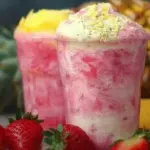 Refreshing anti-inflammatory Pineapple Pink Smoothie in a glass with fruits