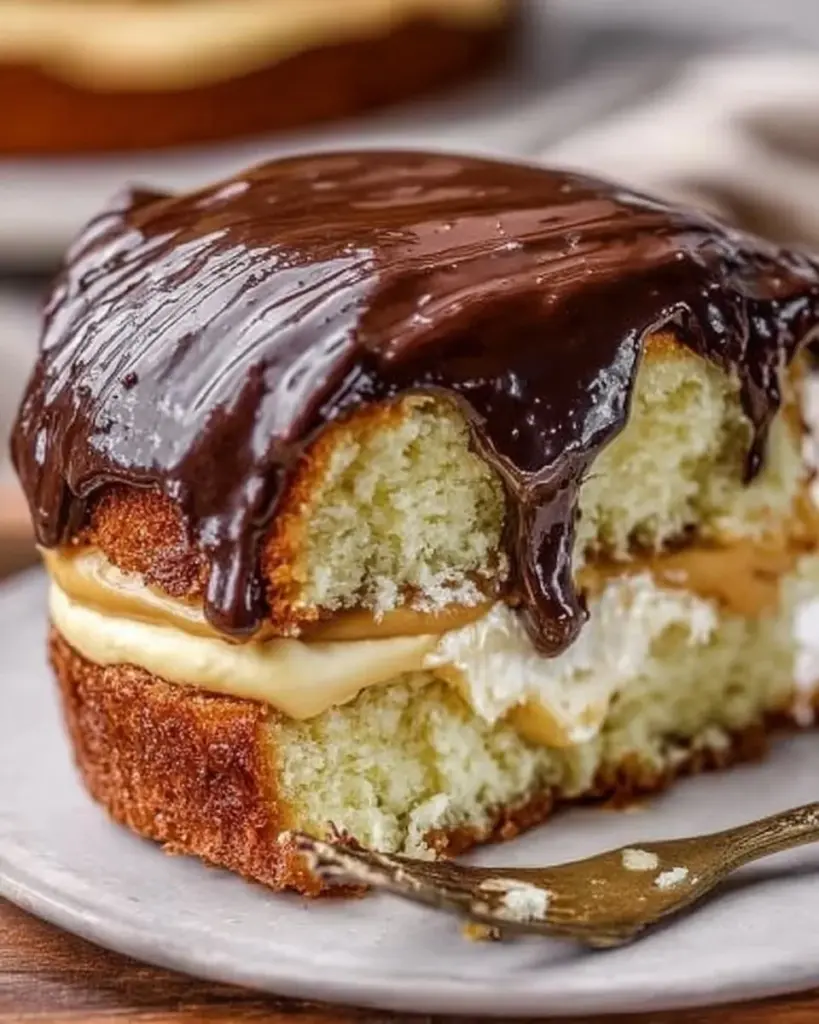 Delicious Boston Cream Pie with layers of custard and chocolate ganache