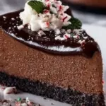 Slice of Chocolate Peppermint Cheesecake topped with whipped cream and chocolate shavings