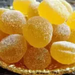 A plate of homemade lemon drops, a sweet and tangy candy treat.