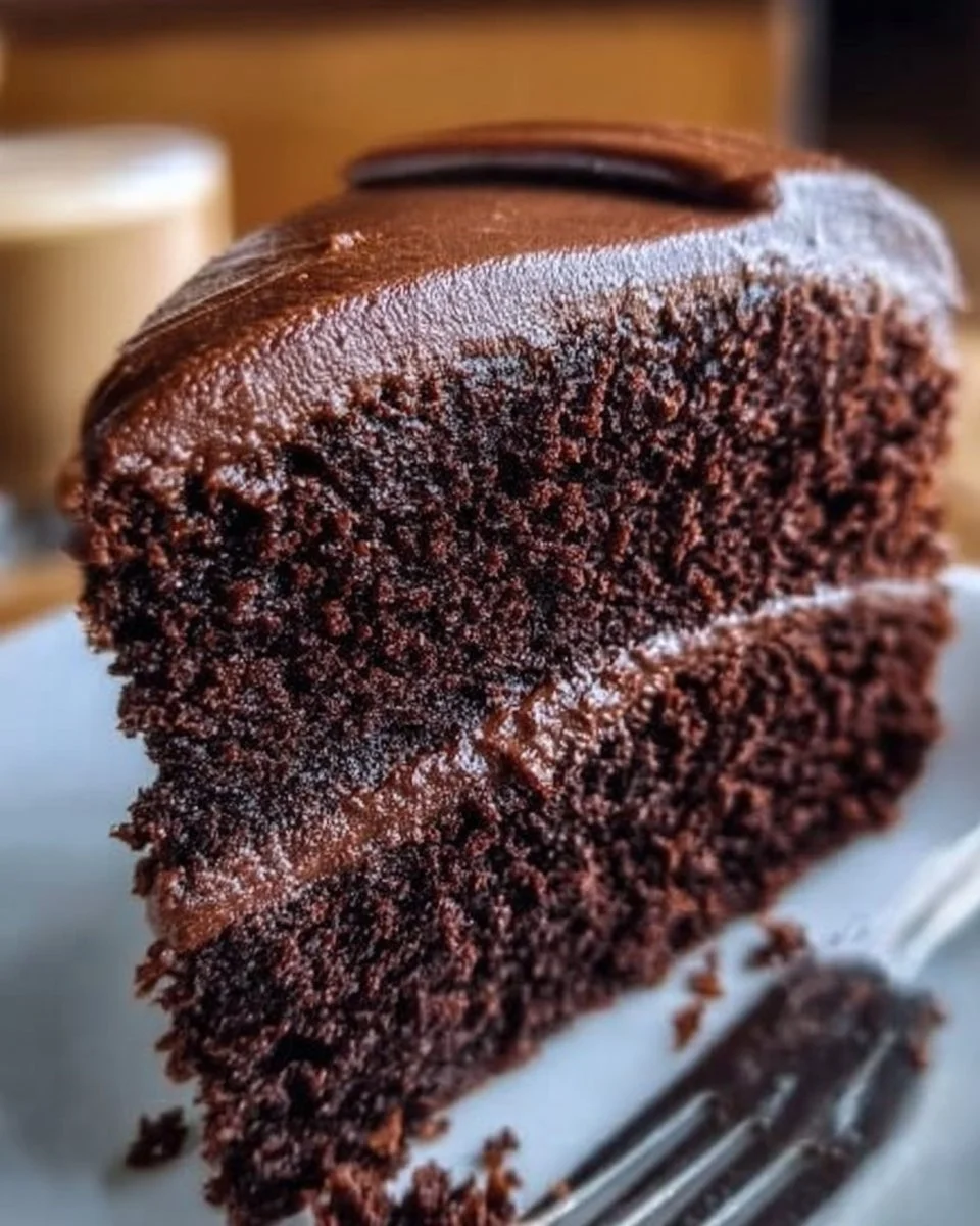 Delicious and moist ultimate chocolate cake slice with chocolate frosting