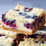 Delicious blueberry cream cheese bars on a plate, perfect for dessert.