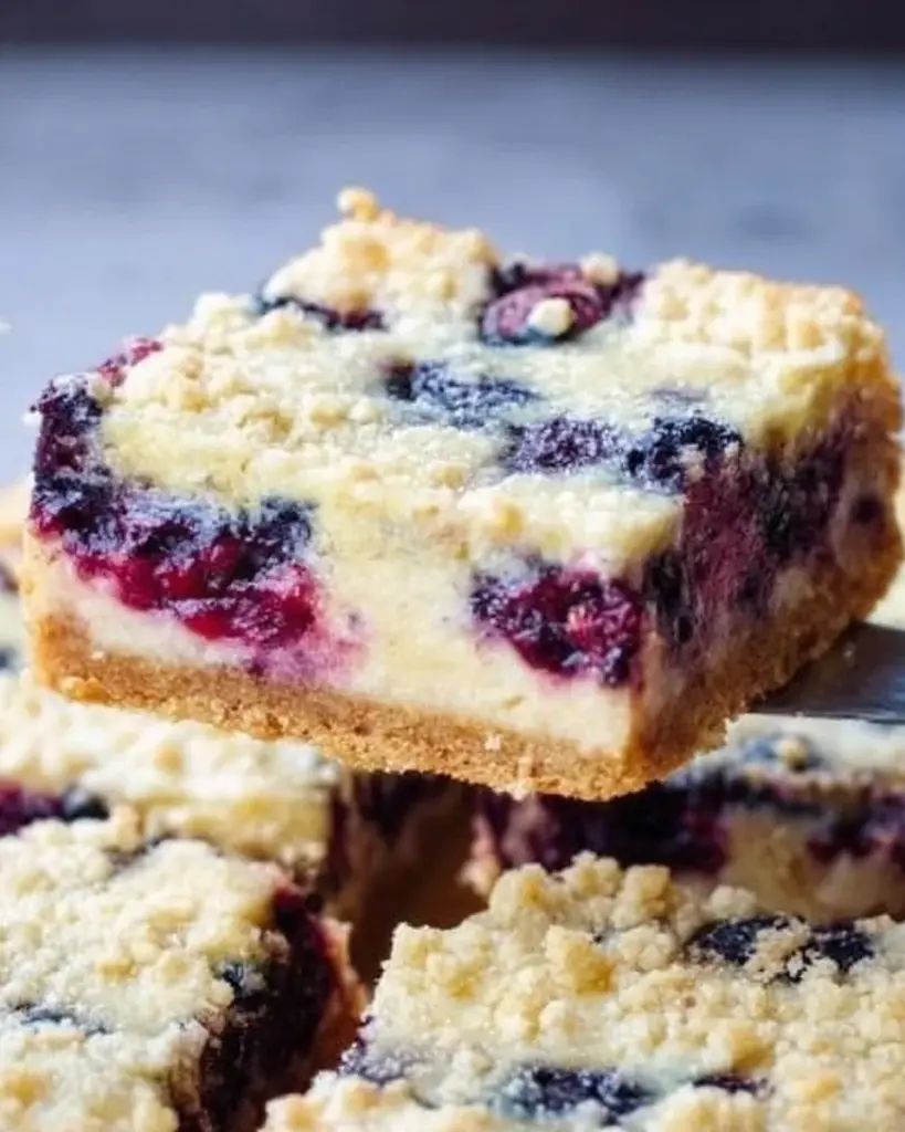 Delicious blueberry cream cheese bars on a plate, perfect for dessert.