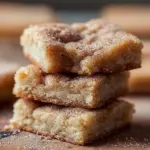 Deliciously baked Cinnamon Sugar Blondies topped with a sweet cinnamon sugar crust.