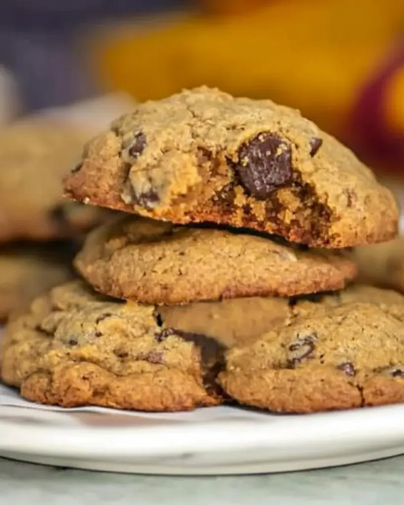 A plate of freshly baked holiday spice cookies with festive decorations.
