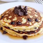 Delicious orange ricotta chocolate chip pancakes stacked on a plate