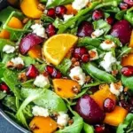 A vibrant winter salad featuring fresh greens, nuts, and seasonal fruits.
