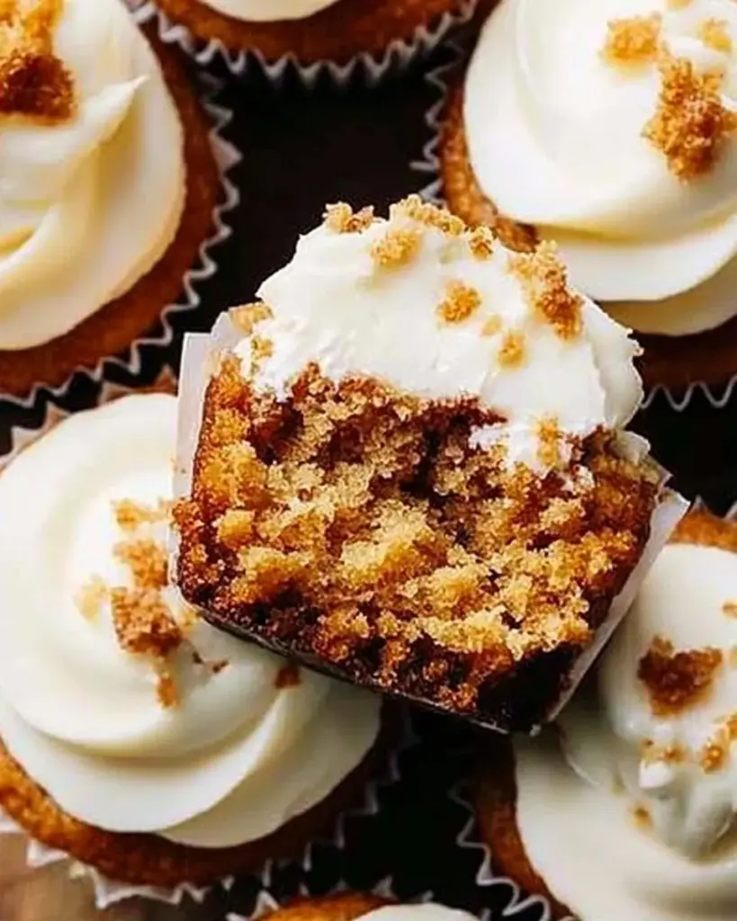 Delicious carrot cake cupcakes topped with cream cheese frosting and decorations