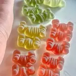 Delicious sour apple and watermelon gummy bears in vibrant colors.