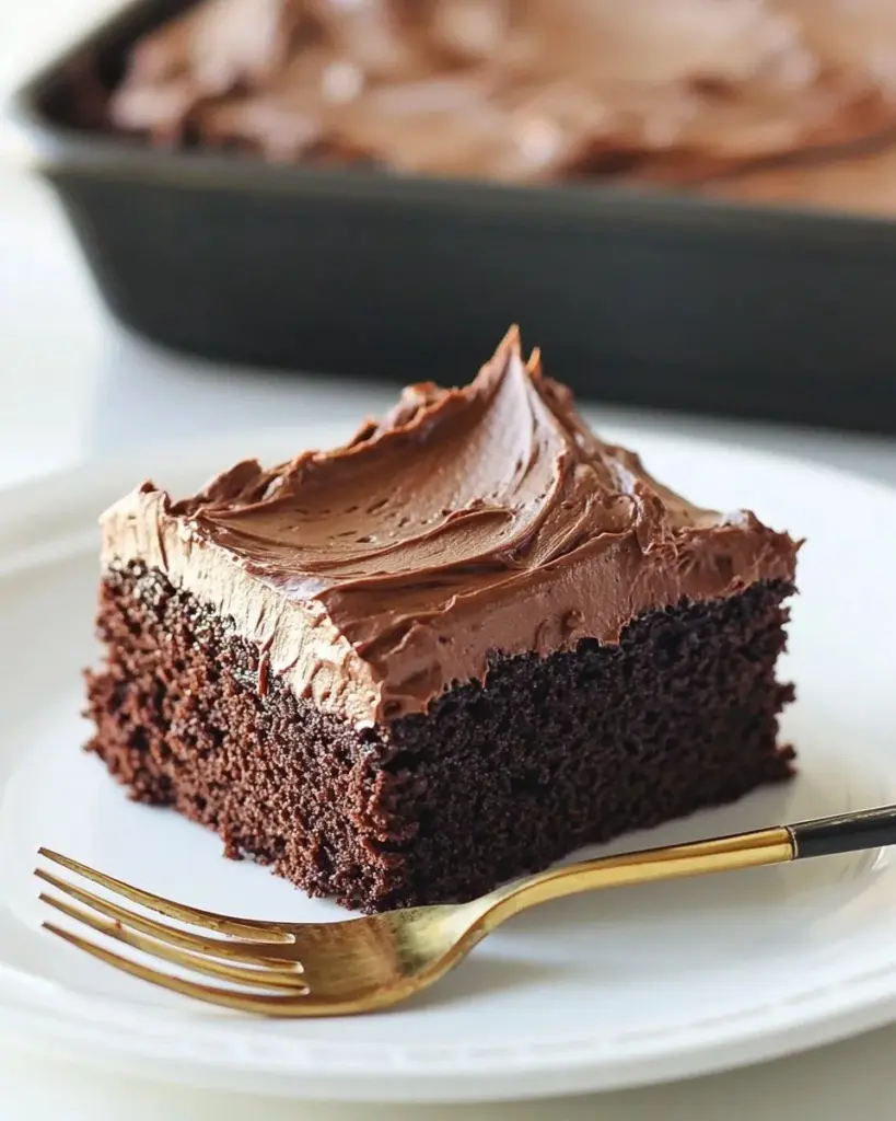 Delicious easy chocolate cake topped with chocolate frosting and sprinkles