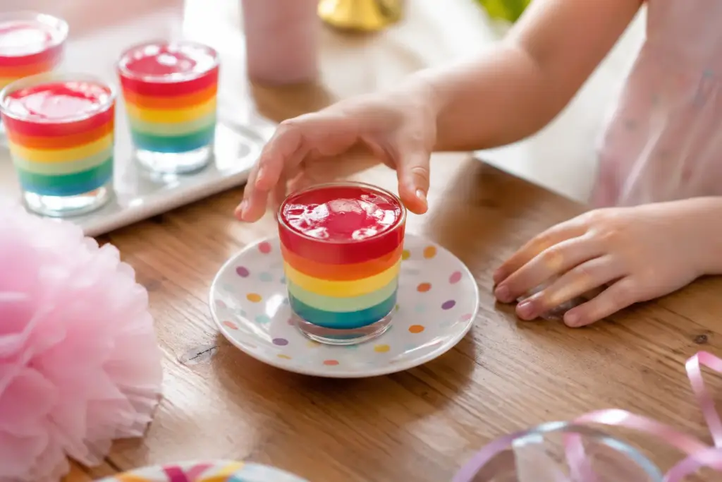 Satisfy Your Curiosity: Easy Horse Gelatin Recipe You’ll Love horse gelatin trick for kids Rainbow layered jelly cups arranged for a kids' party