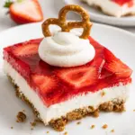 Delicious strawberry pretzel salad with a pretzel crust, cream cheese filling, and strawberry topping.